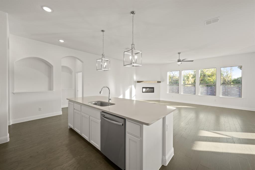 701 Seahawk Street Joshua, TX 76058 - Photo 6 of 30 a large kitchen with kitchen island a sink appliances and a large window