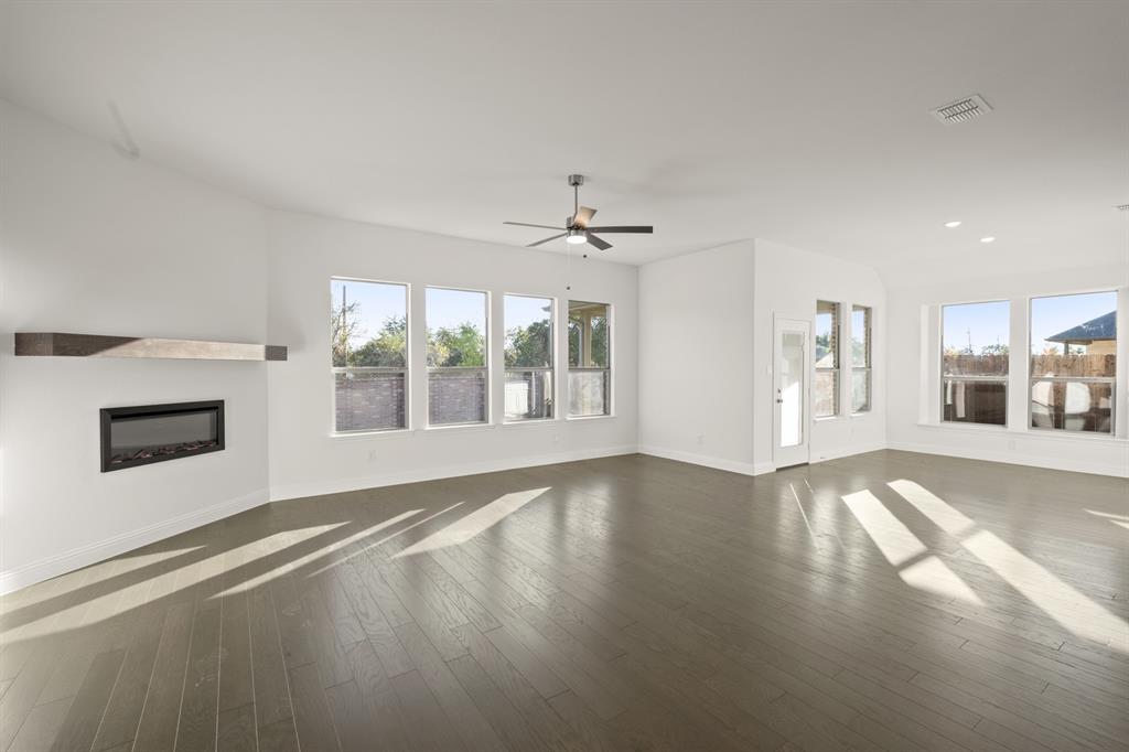 701 Seahawk Street Joshua, TX 76058 - Photo 8 of 30 a view of an empty room with a fireplace and a window