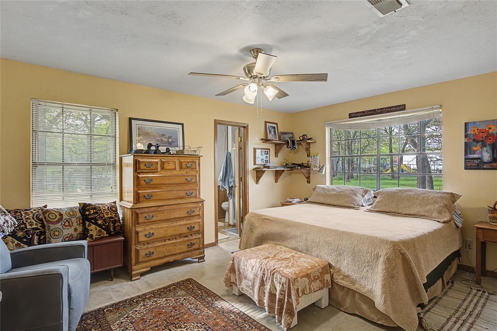 243 County Road 3851 Poolville, TX 76487 - Photo 16 of 34 a bedroom with a bed and a large window