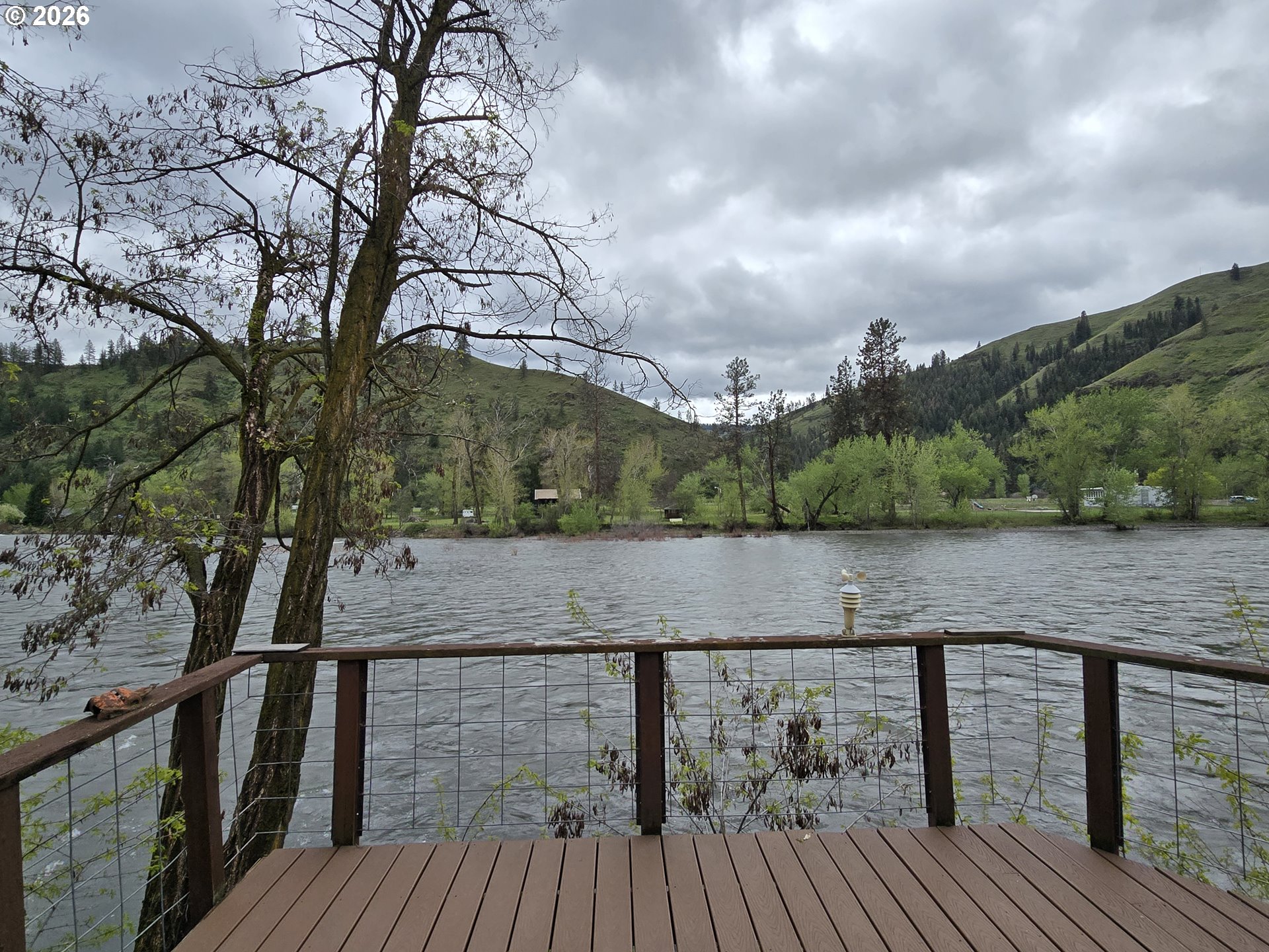 84665 Grande Ronde Road Enterprise, OR 97828 - Photo 2 of 27 a view of house with mountain and trees in the background