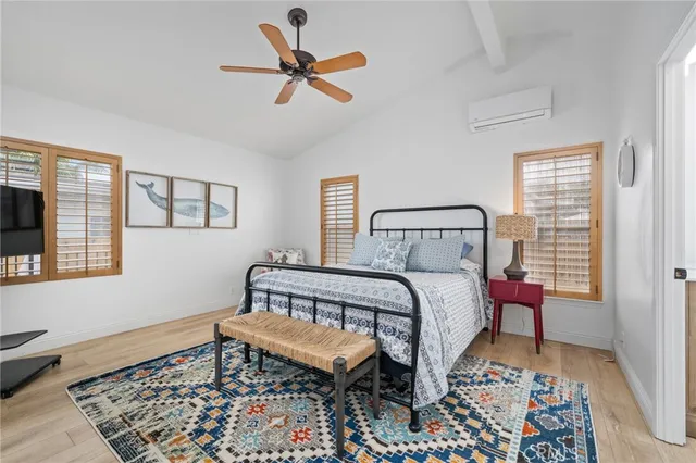 a bedroom with bed and a mirror