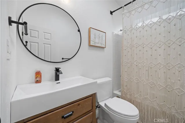 a view of a livingroom with furniture and hallway