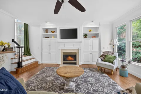 a living room with furniture a flat screen tv and a fireplace