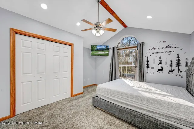 a bedroom with a large bed and a chandelier