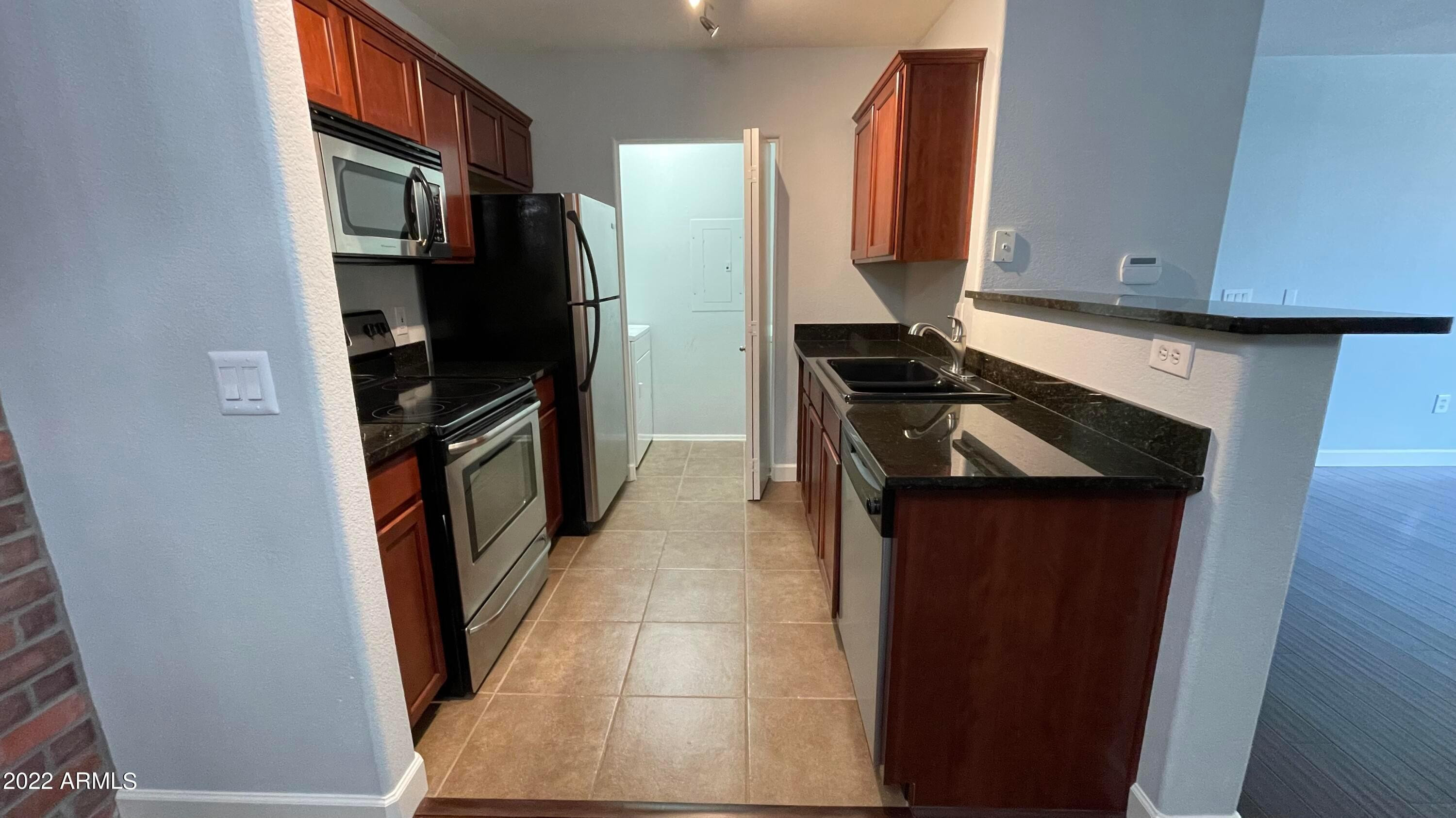 3302 North 7th Street, Unit 222 Phoenix, AZ 85014 - Photo 13 of 30 a kitchen with a refrigerator stove and cabinets