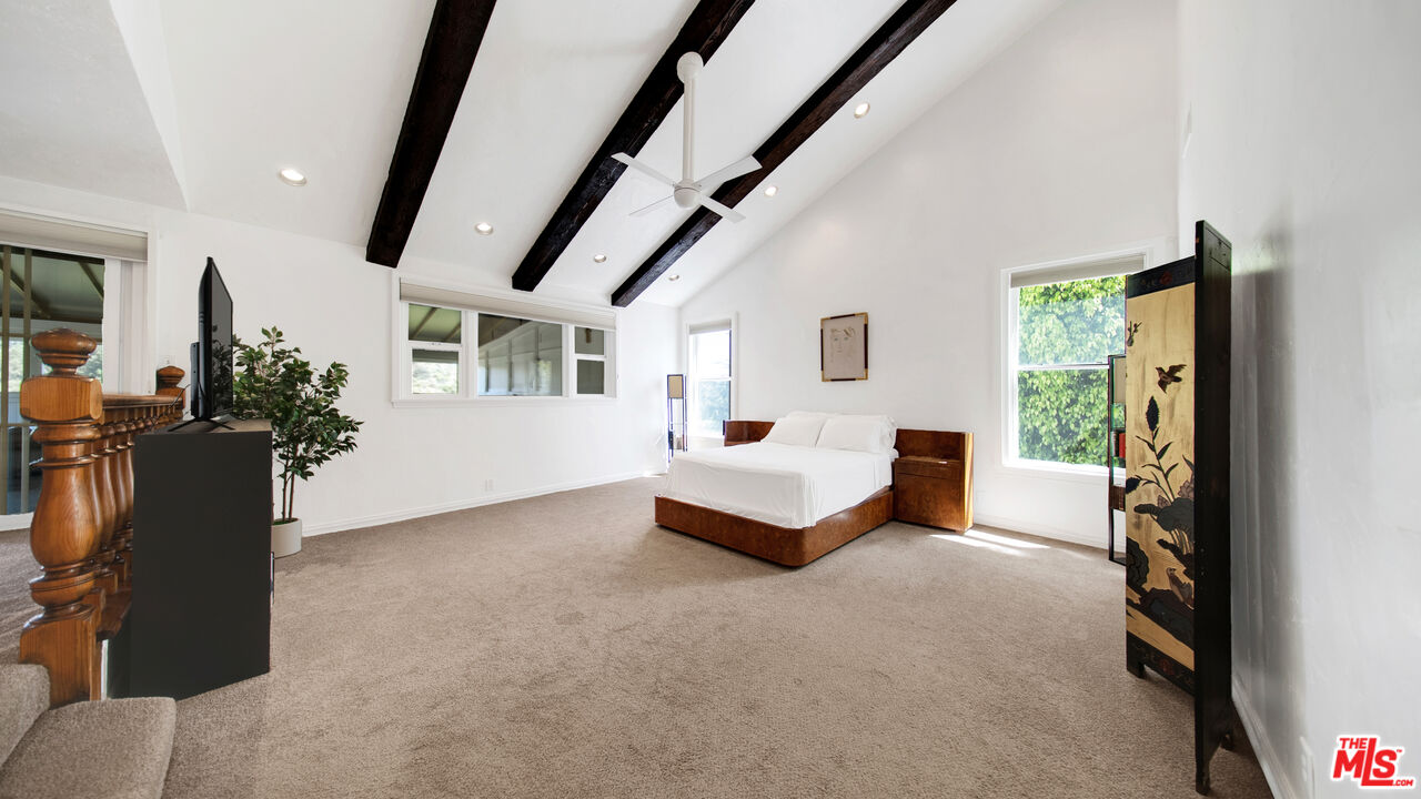 2312 Kimridge Road Beverly Hills, CA 90210 - Photo 38 of 60 a bedroom with furniture and a window