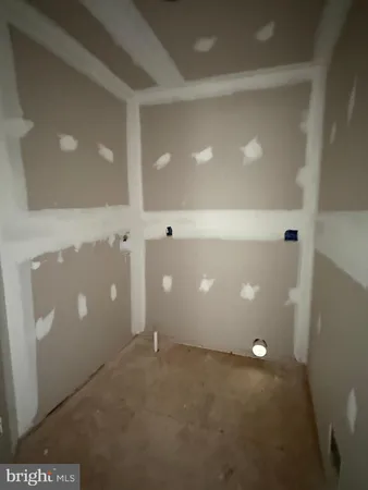 a bedroom with a bed couch and a window