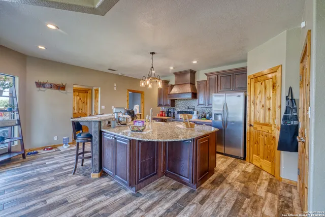 a kitchen with stainless steel appliances a sink stove and cabinets