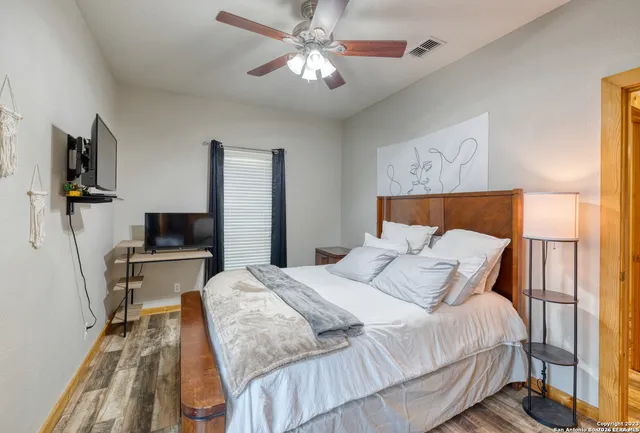 a bedroom with a bed and a flat screen tv