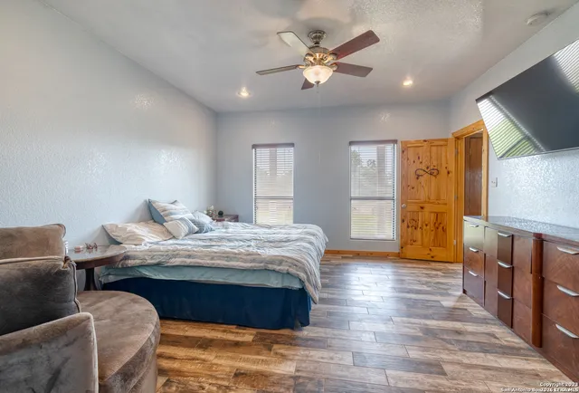 a spacious bedroom with a bed and a chandelier