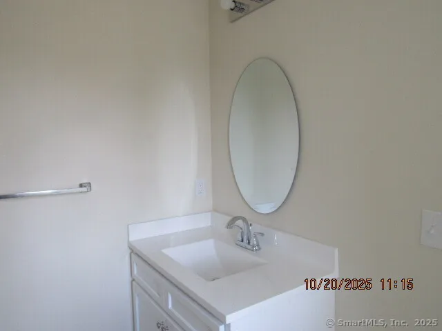 a bathroom with a sink vanity and a mirror