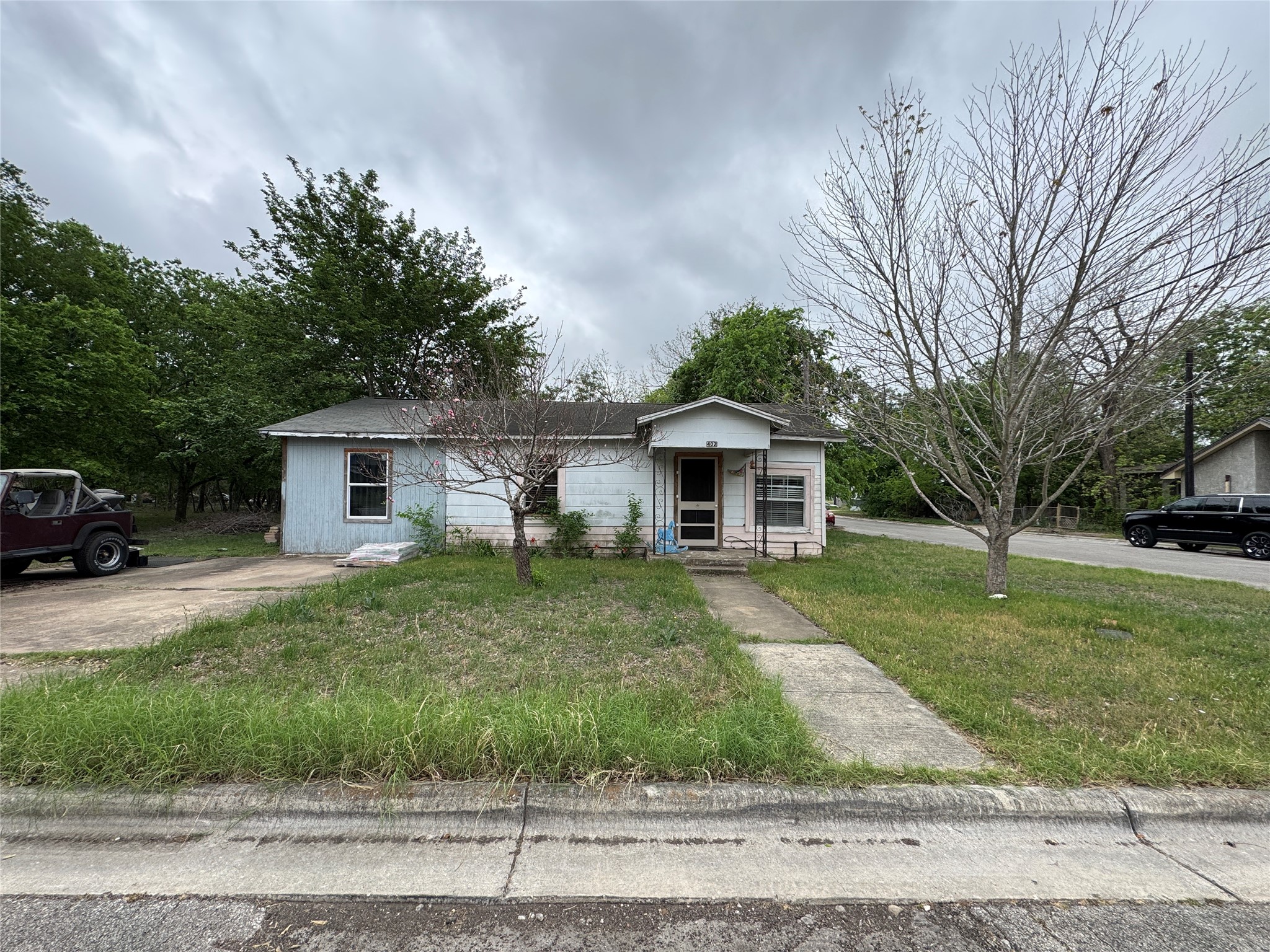 402 Laredo Street Lockhart, TX 78644 - Photo 1 of 12 a front view of a house with a yard and garage