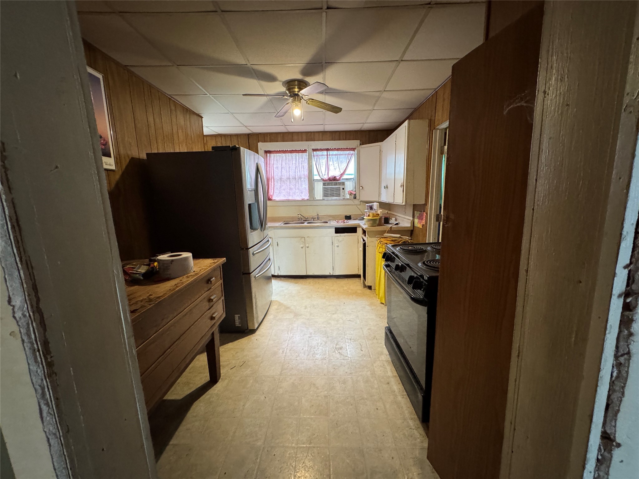 402 Laredo Street Lockhart, TX 78644 - Photo 11 of 12 a kitchen with a refrigerator and a sink