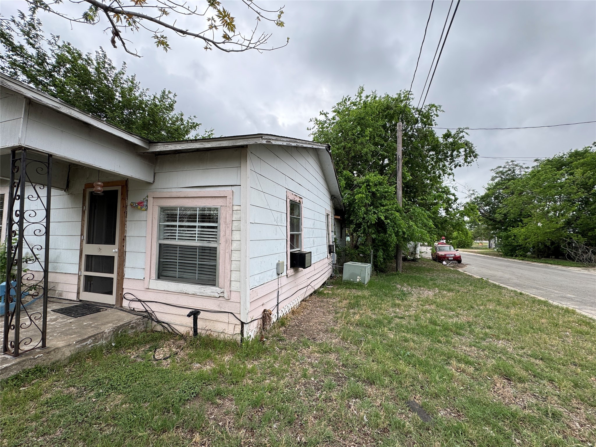 402 Laredo Street Lockhart, TX 78644 - Photo 2 of 12 a house with trees in the background