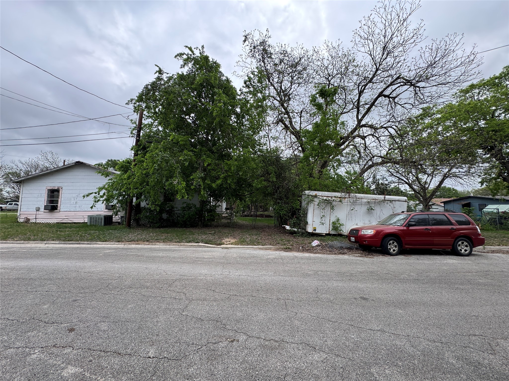 402 Laredo Street Lockhart, TX 78644 - Photo 3 of 12 a front view of a house with a yard and garage