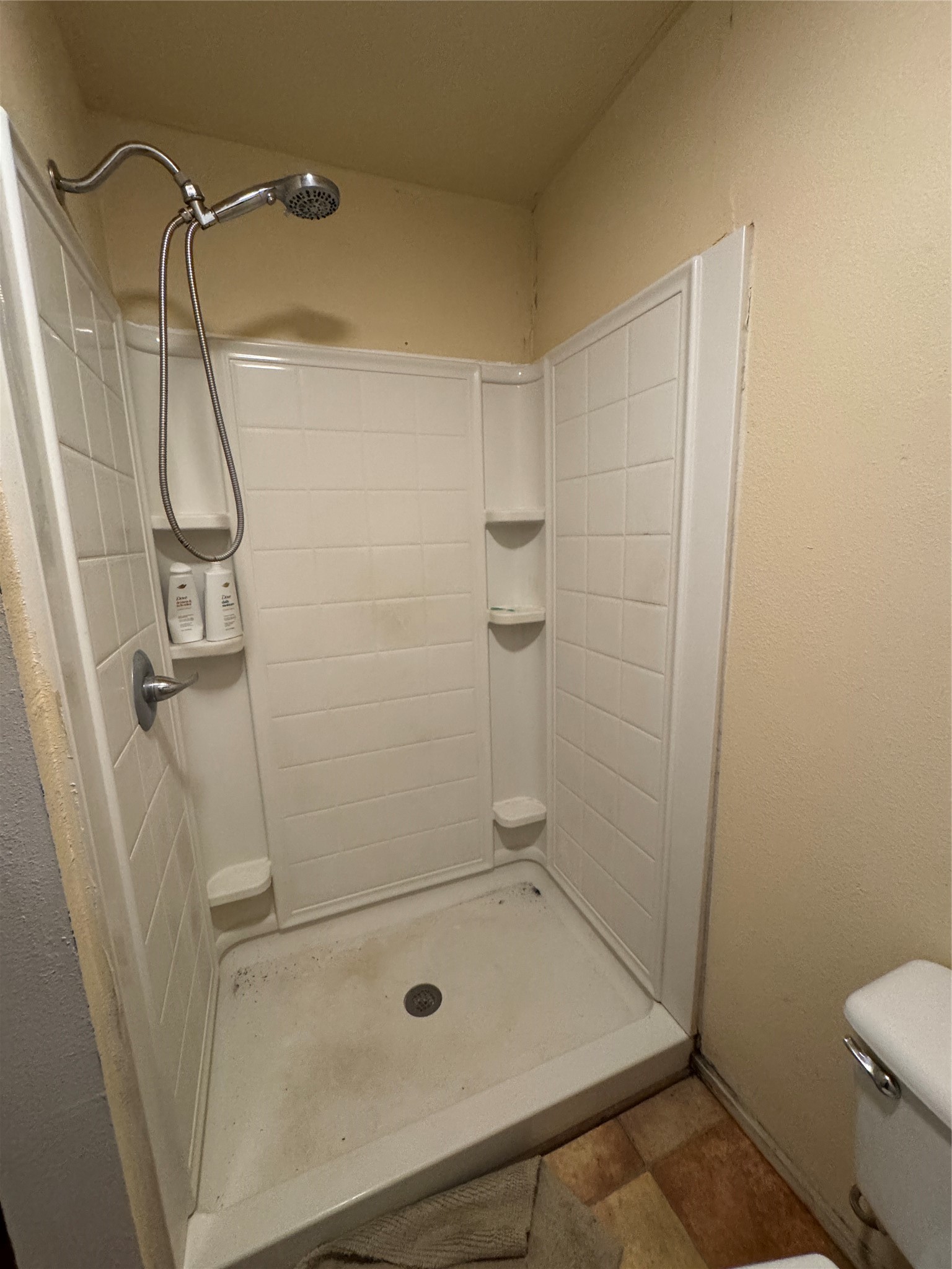 402 Laredo Street Lockhart, TX 78644 - Photo 8 of 12 a bathroom with a shower and toilet