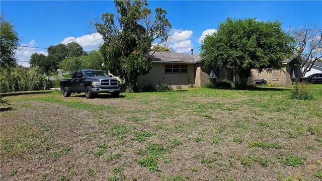 a car parked in front of yellow house