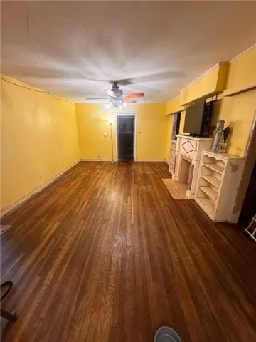 a view of a room with wooden floor
