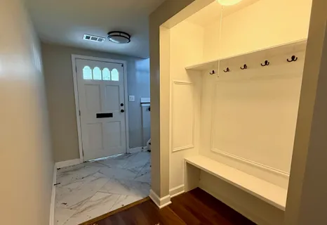 a view of walk in closet with wooden floor