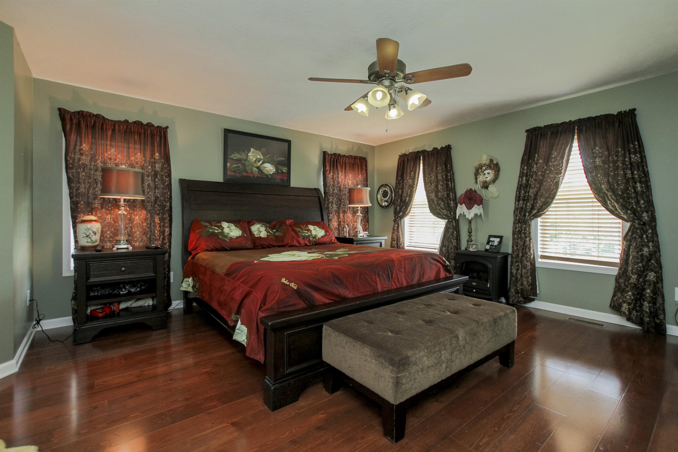 215 Buffalo Road Pleasant Shade, TN 37145 - Photo 14 of 30 a bedroom with a bed chandelier and window