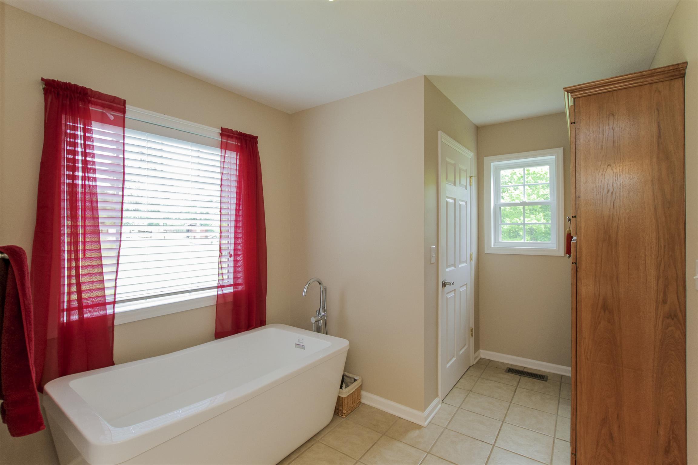 215 Buffalo Road Pleasant Shade, TN 37145 - Photo 16 of 30 a bathroom with a bathtub and a window