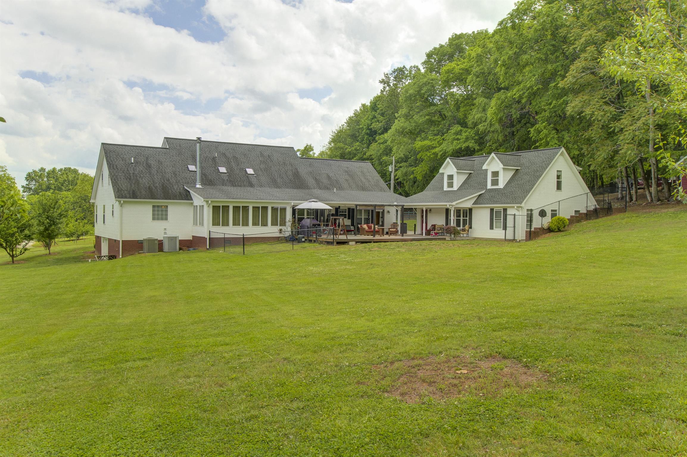 215 Buffalo Road Pleasant Shade, TN 37145 - Photo 2 of 30 a front view of a house with a garden and lake view