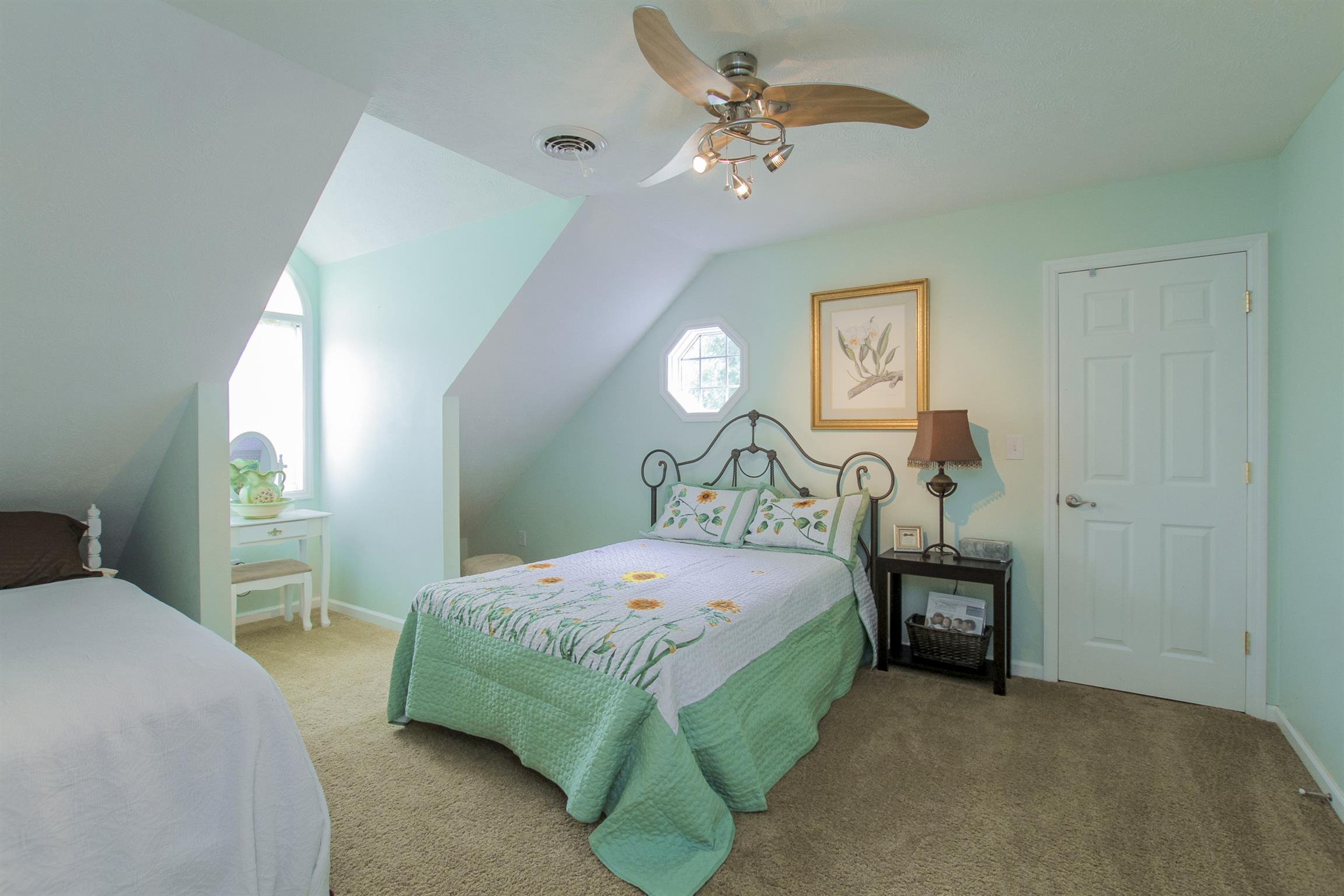 215 Buffalo Road Pleasant Shade, TN 37145 - Photo 22 of 30 a bedroom with a bed and a chandelier