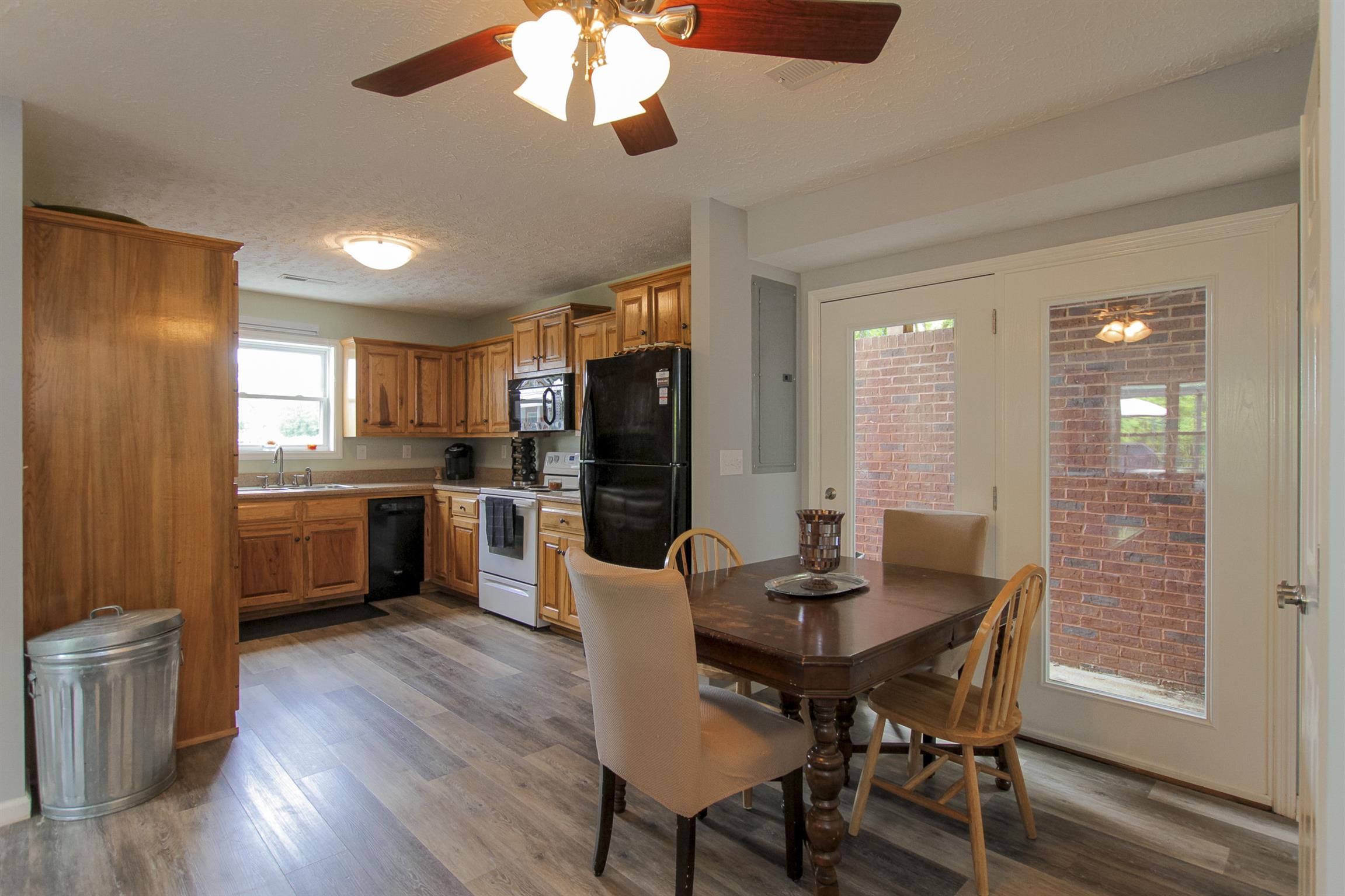 215 Buffalo Road Pleasant Shade, TN 37145 - Photo 27 of 30 a kitchen with a table chairs refrigerator and cabinets