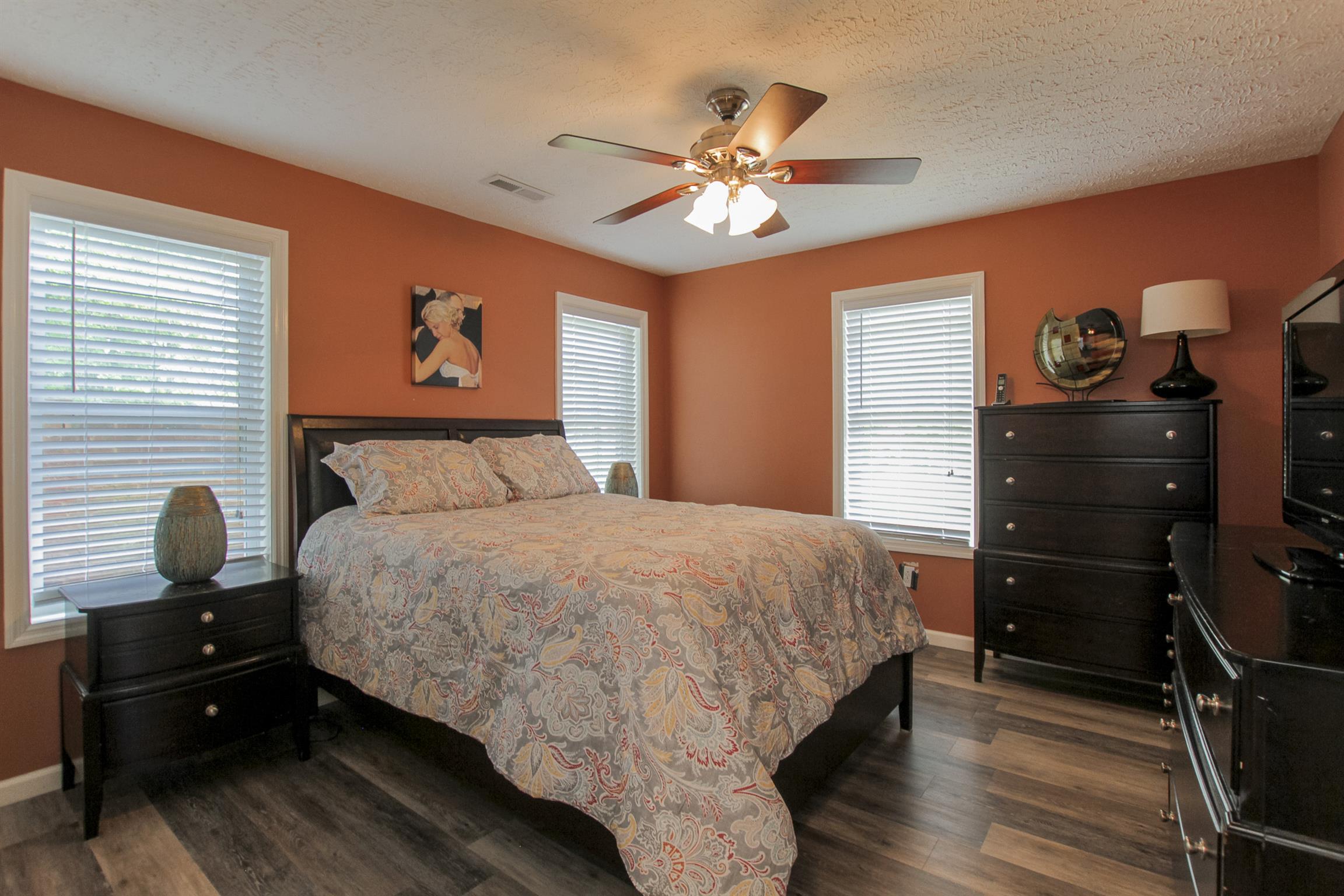 215 Buffalo Road Pleasant Shade, TN 37145 - Photo 28 of 30 a bedroom with a bed and wooden floor