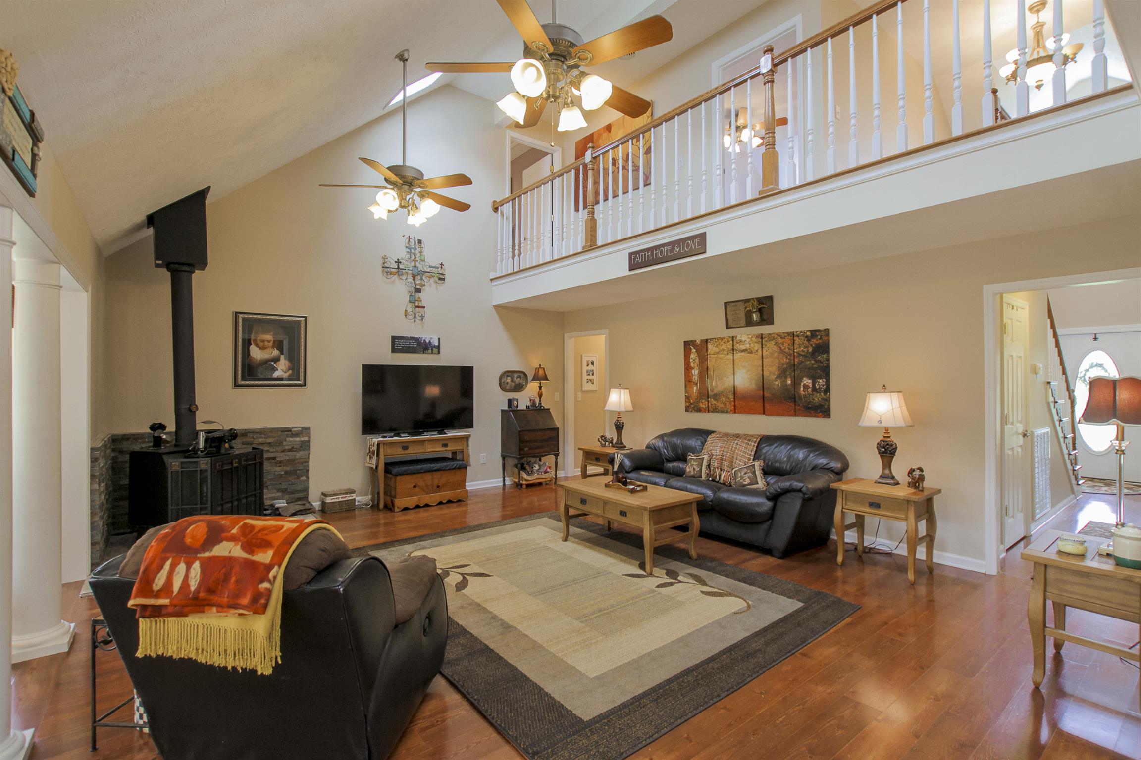 215 Buffalo Road Pleasant Shade, TN 37145 - Photo 5 of 30 a living room with furniture a flat screen tv and a fireplace