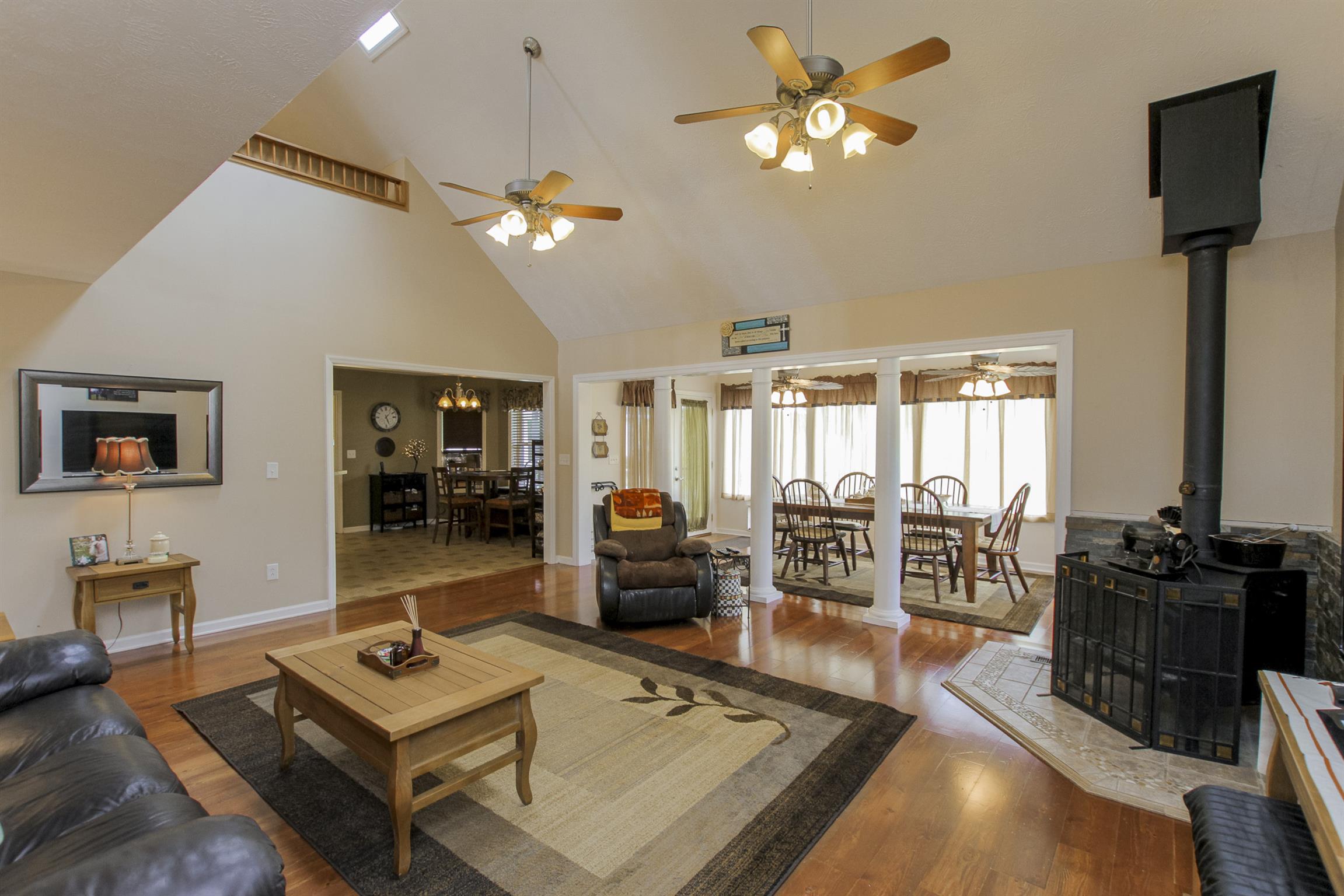 215 Buffalo Road Pleasant Shade, TN 37145 - Photo 6 of 30 a living room with furniture a chandelier and a flat screen tv