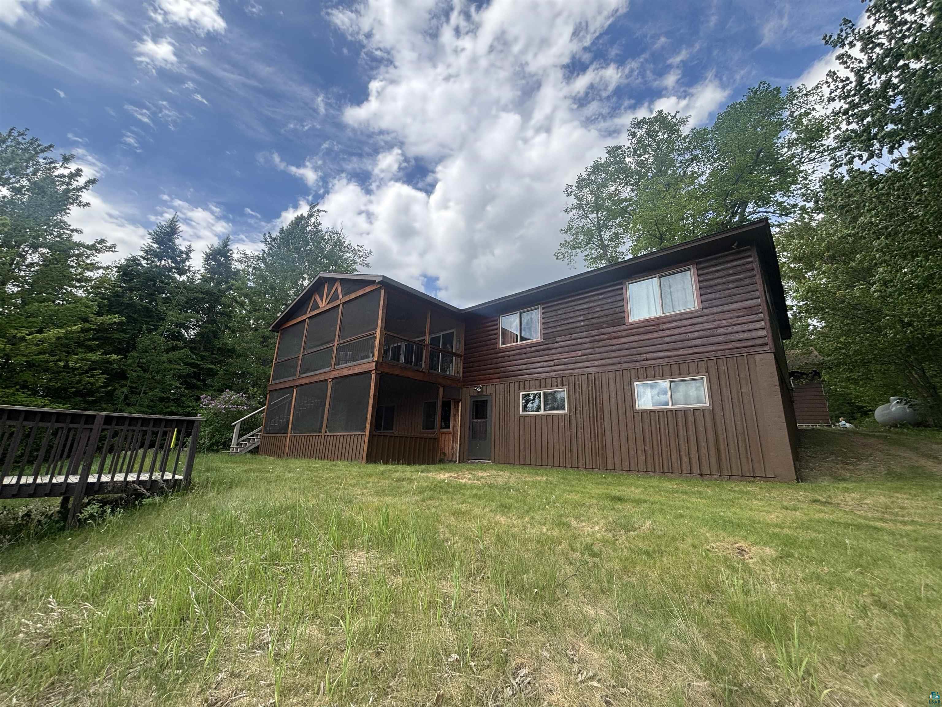 444 Fernberg Road, Unit 11 Ely, MN 55731 - Photo 2 of 20 Two-story home with wood siding and an elevated screened-in porch