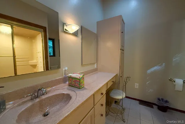 a bathroom with a sink double vanity and a mirror