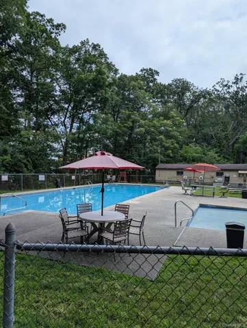 a white house sitting next to a lake