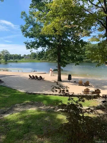 an aerial view of a house with swimming pool and outdoor seating
