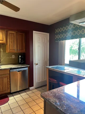 a kitchen with stainless steel appliances granite countertop a sink and a stove