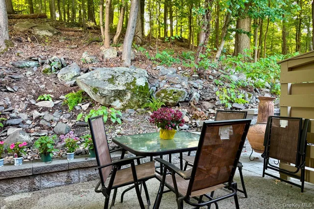 a dining area with furniture and garden view