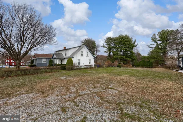 a view of white house with a yard