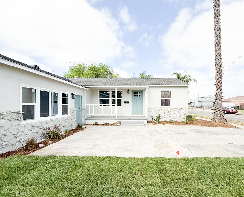 a front view of a house with a garden and patio