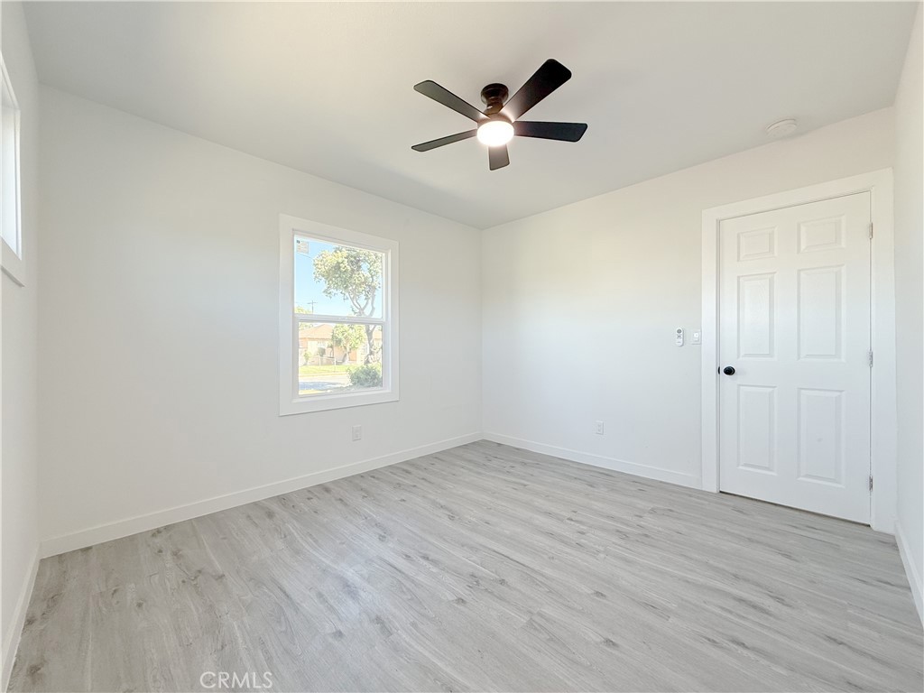 511 North Albertson Avenue Compton, CA 90220 - Photo 11 of 25 an empty room with wooden floor and windows