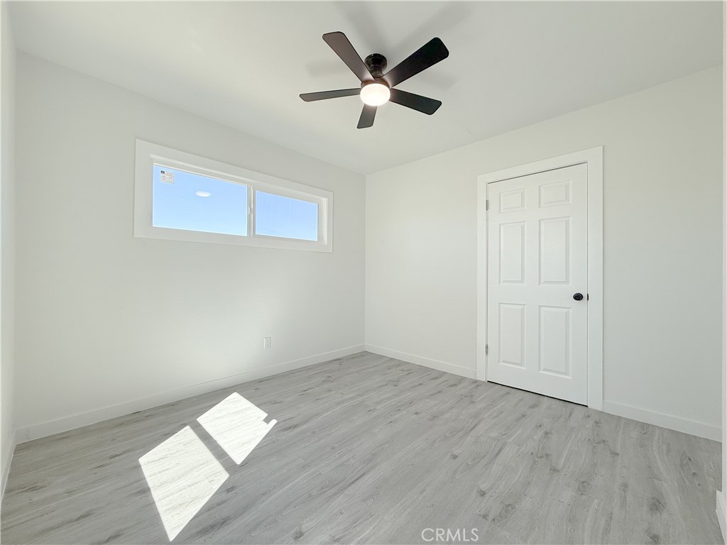 511 North Albertson Avenue Compton, CA 90220 - Photo 13 of 25 an empty room with wooden floor and ceiling fan