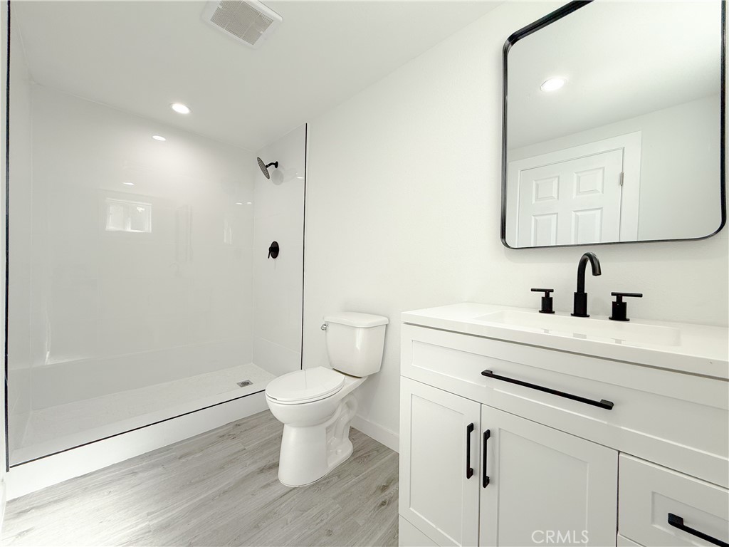 511 North Albertson Avenue Compton, CA 90220 - Photo 15 of 25 a bathroom with a sink toilet a mirror and shower