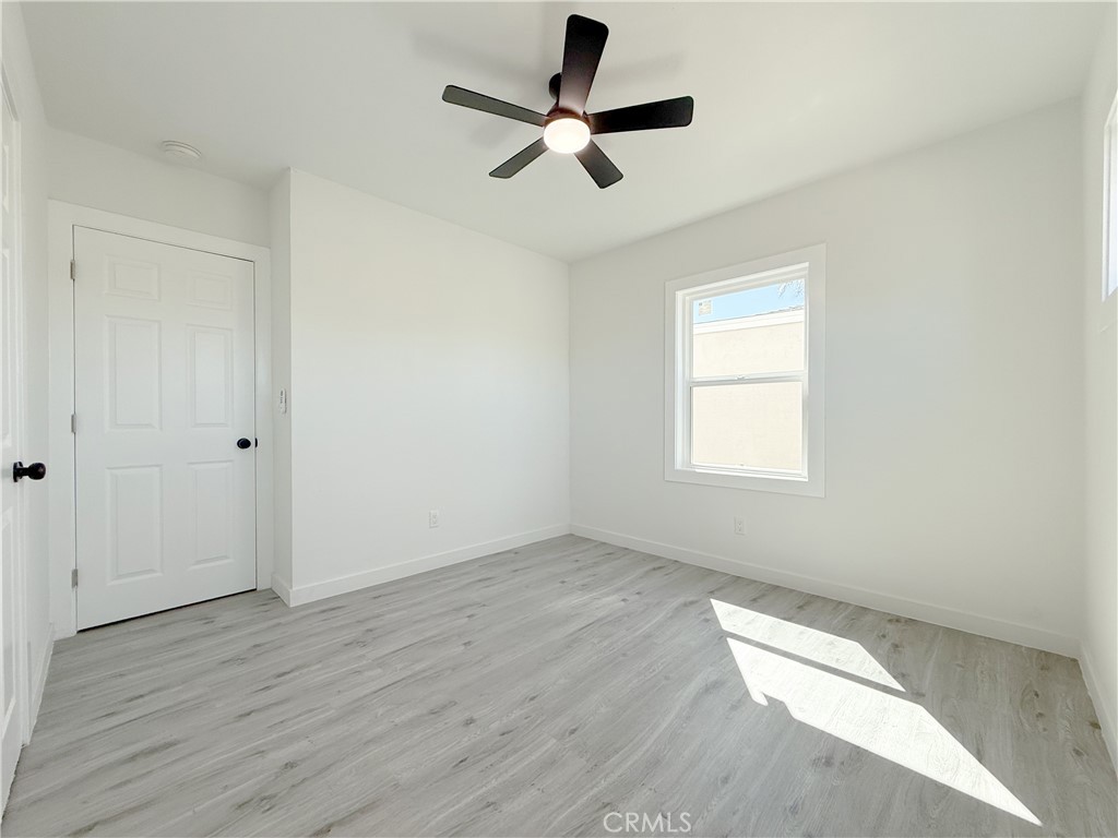 511 North Albertson Avenue Compton, CA 90220 - Photo 19 of 25 an empty room with wooden floor ceiling fan and windows