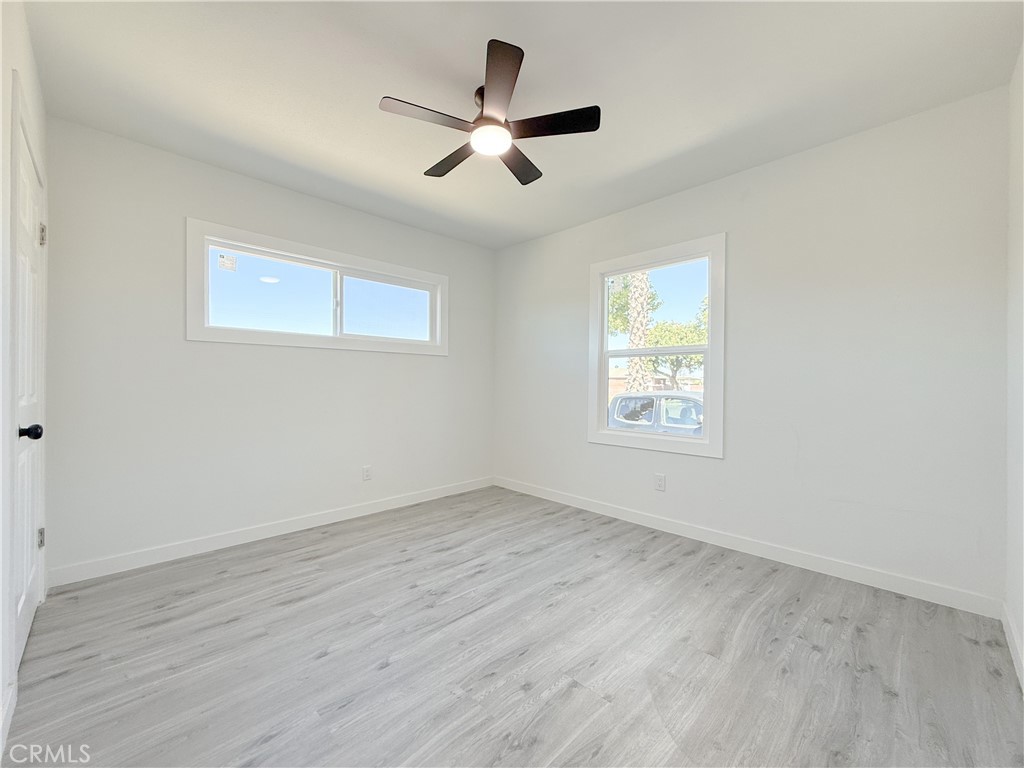 511 North Albertson Avenue Compton, CA 90220 - Photo 20 of 25 an empty room with wooden floor ceiling fan and window