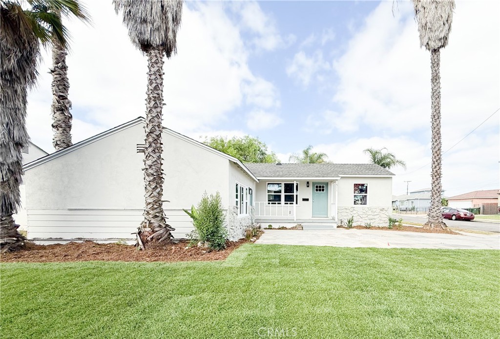 511 North Albertson Avenue Compton, CA 90220 - Photo 2 of 25 a front view of a house with a garden and yard