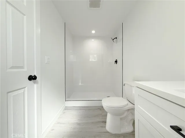 a bathroom with a toilet a sink and shower