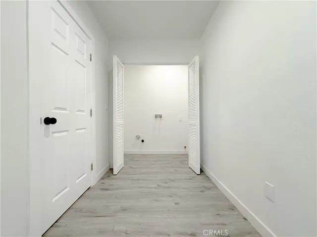 a view of a room with wooden floor