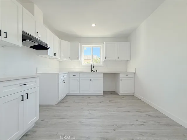 a kitchen with cabinets stainless steel appliances and a sink