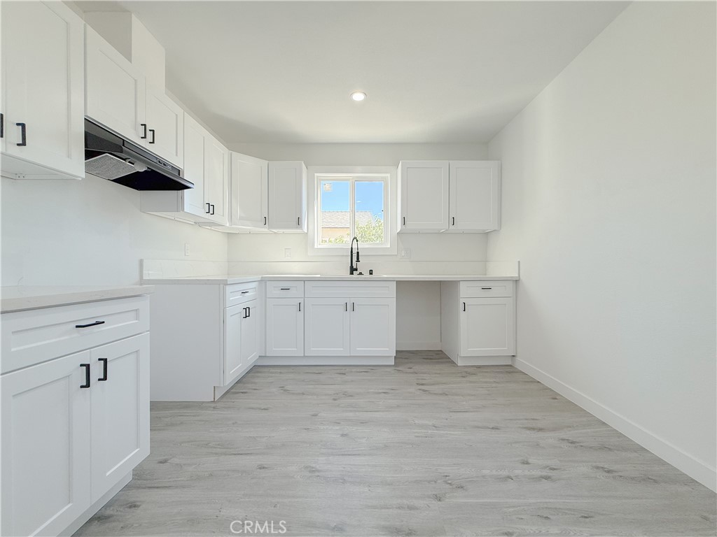 511 North Albertson Avenue Compton, CA 90220 - Photo 5 of 25 a kitchen with cabinets stainless steel appliances and a sink