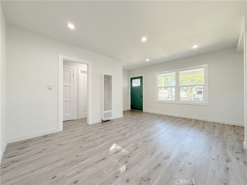 511 North Albertson Avenue Compton, CA 90220 - Photo 8 of 25 an empty room with wooden floor and windows
